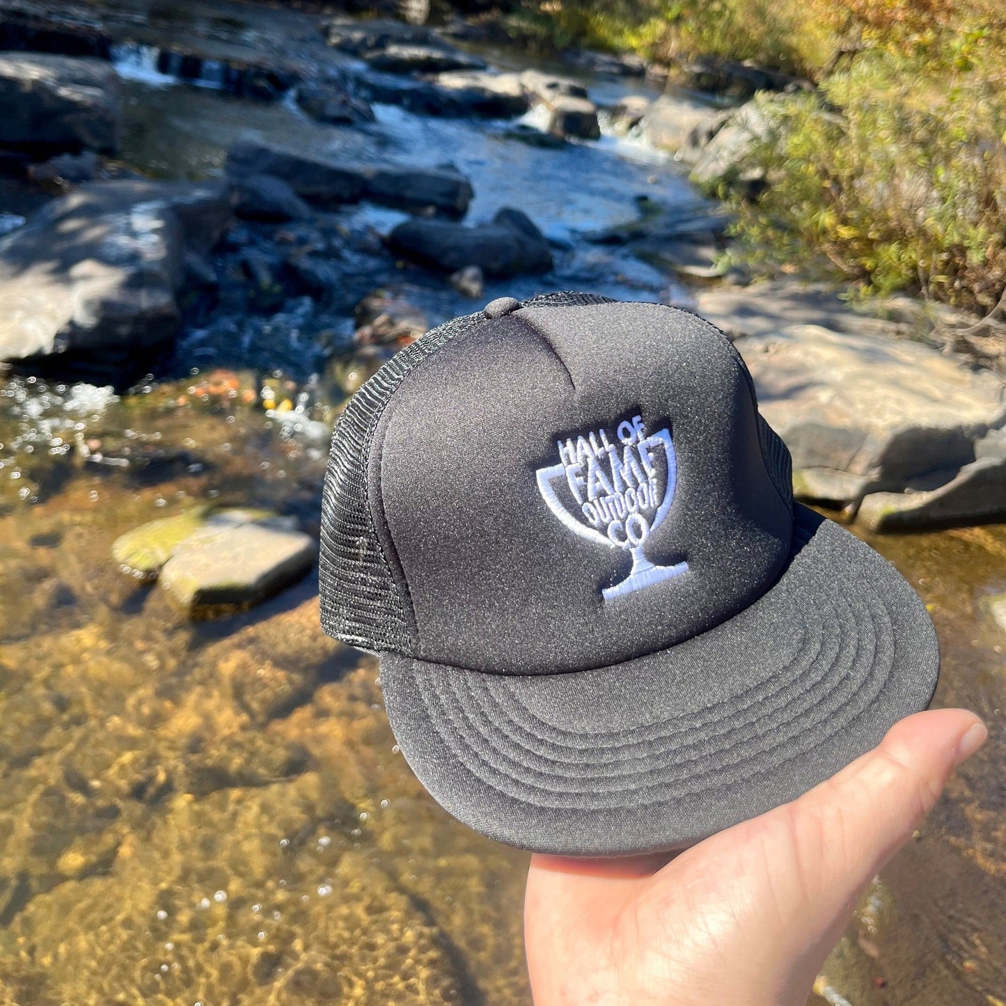 retro hofo trucker hat. black. front. holding.