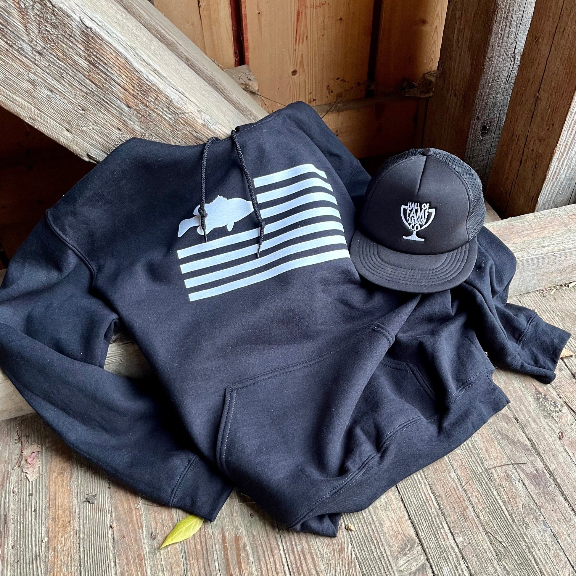 freedom fish hoodie. black. front with hat.